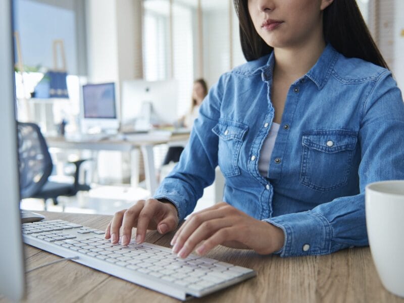 Close up of woman typing on computer keyboard
