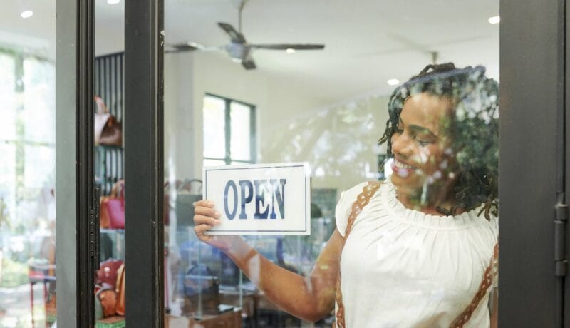 Shop assistant opening store