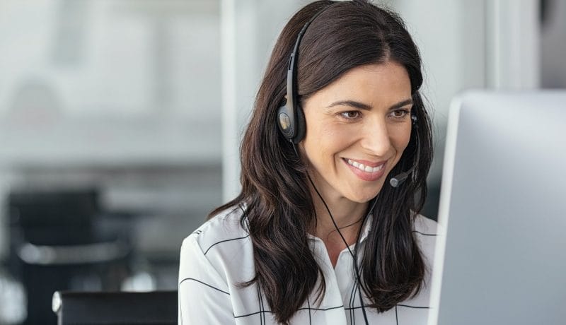 Smiling latin woman in call center